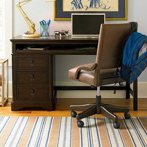 The Paula Deen Henry’s desk built of poplar veneers and hardwood solids with a molasses finish. Featuring one file drawer, one box drawer, a pull-out tray for keyboard, and charging station. A interchangeable pedestal and leg allows for easy right or left hand use.