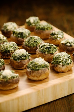 Whether you're throwing a full-blown holiday party or if you just want a warm snack to welcome your houseguests with, Paula Deen's Cheese Stuffed Mushrooms are a delicious snack that are easy to prepare. Simply fill fresh mushroom caps with a mixture of spinach, feta cheese, cream cheese and green onions, and then top with Parmesan cheese. Bake it in the oven for 15 to 20 minutes and enjoy!