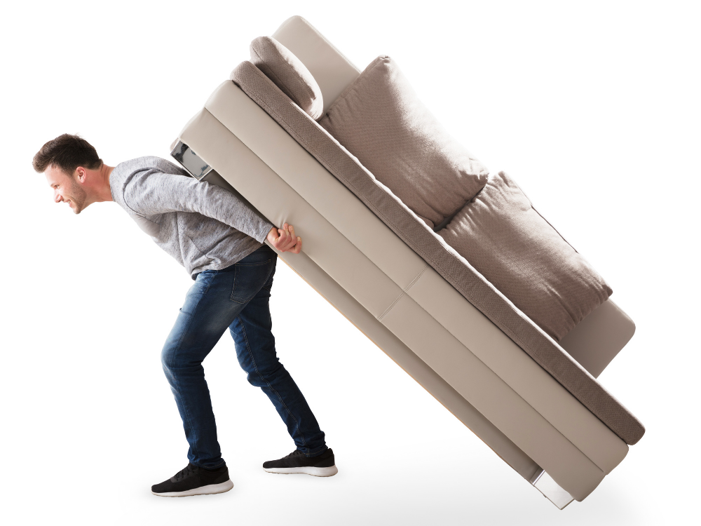 man struggling to carry couch
