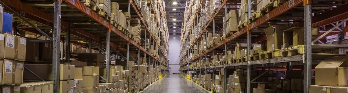 We Have Stock! - (678) 255-1000 - Woodstock Furniture & Mattress Outlet photo from inside Woodstock Furniture & Mattress Outlet's distribution center showing a huge row of warehouse space packed with boxes