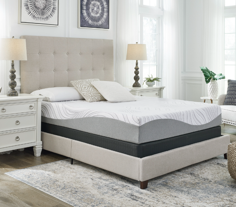 sierra sleep peak memory foam mattress m592 on a bed frame displayed in a bedroom