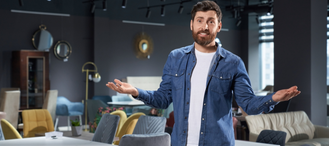man-gesturing-with-open-arms-in-furniture-store-what-to-do